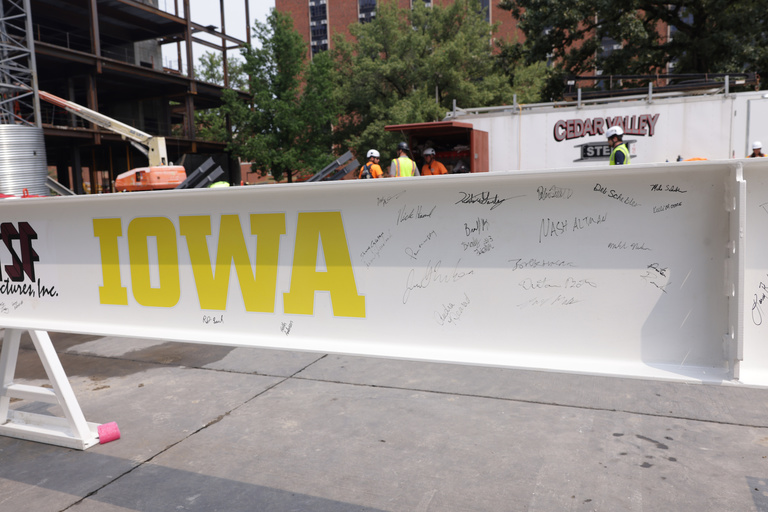 Construction workers and UI leadership and staff sign a beam during construction of the Health Sciences Academic Building (HSAB) on the west side of the University of Iowa campus Wednesday, July 24, 2024.