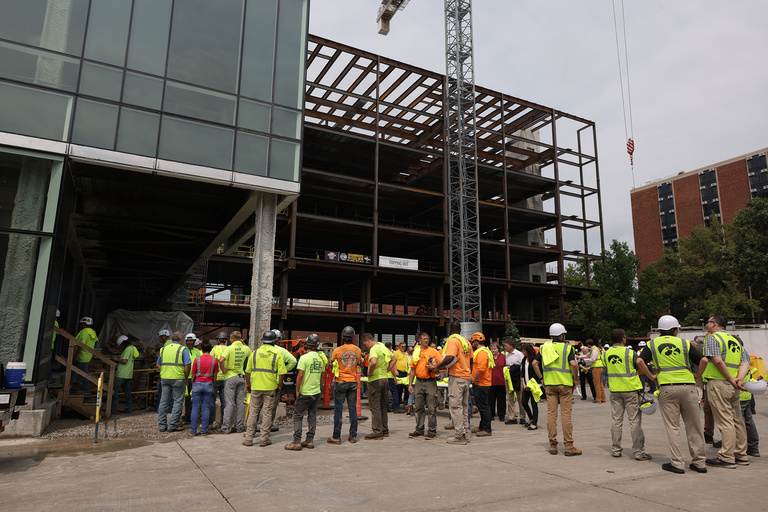 Construction workers and UI leadership and staff sign a beam during construction of the Health Sciences Academic Building (HSAB) on the west side of the University of Iowa campus Wednesday, July 24, 2024. 